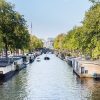 Canal Prinsengracht din Amsterdam cu case plutitoare și bărci, destinație city break Europa 2026